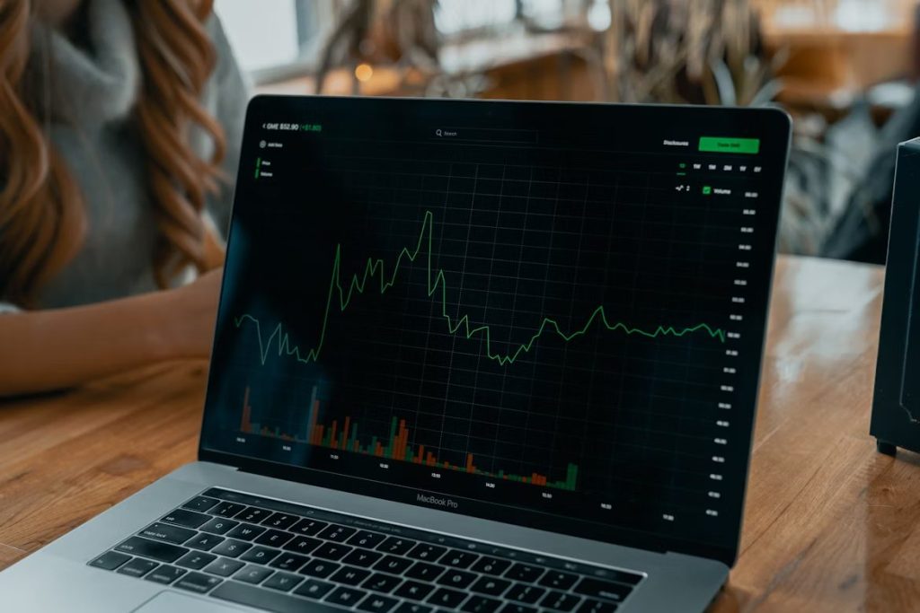 Laptop displaying financial market graph